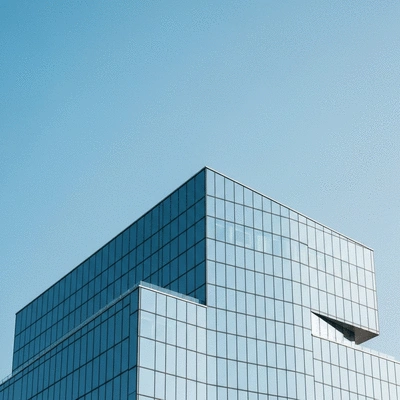 Modern office building facade reflecting a clear sky, symbolizing growth and opportunity in commercial real estate, no text, no words, no typography